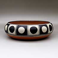 A large, shallow polychrome bowl decorated inside with a bird, wave and geometric design, and decorated around the shoulder with a band of geometric design, click or tap to see a larger version