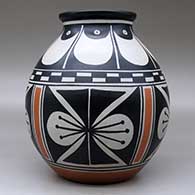 A polychrome jar with a flared rim and decorated with a four-panel butterfly and geometric design, click or tap to see a larger version