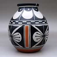 A polychrome jar with a flared rim and decorated with a four-panel butterfly and geometric design, click or tap to see a larger version