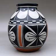 A polychrome jar with a flared rim and decorated with a four-panel butterfly and geometric design, click or tap to see a larger version