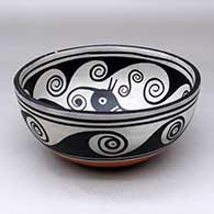 A polychrome bowl decorated with a bird and geometric design inside, and with a spiral and geometric design outside, click or tap to see a larger version