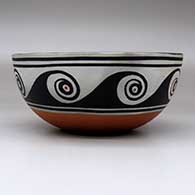 A polychrome bowl decorated with a bird and geometric design inside, and with a spiral and geometric design outside, click or tap to see a larger version