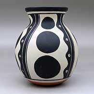 A polychrome jar with a flared rim and decorated with a four panel geometric design, click or tap to see a larger version