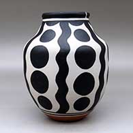 A polychrome jar decorated with a four-panel geometric design, click or tap to see a larger version
