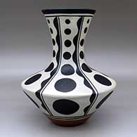 A polychrome vase decorated with a six-panel geometric design, click or tap to see a larger version