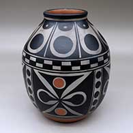 A polychrome jar decorated around the body with a four-panel butterfly and geometric design, and above the shoulder with a geometric design
 by Thomas Tenorio of Santo Domingo