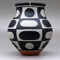 A polychrome jar decorated with a six-panel geometric design, click or tap to see a larger version