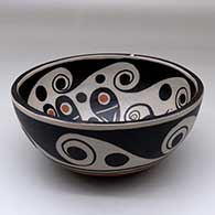 A polychrome chili bowl decorated with a bird and water symbol geometric design inside, and a water symbol geometric design outside, click or tap to see a larger version