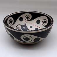 A polychrome chili bowl decorated with a bird and water symbol geometric design inside, and a water symbol geometric design outside, click or tap to see a larger version