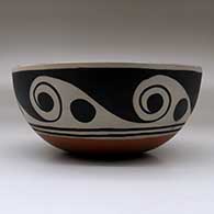 A polychrome chili bowl decorated with a bird and water symbol geometric design inside, and a water symbol geometric design outside, click or tap to see a larger version