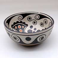 A polychrome chili bowl decorated with a fish and water symbol design inside, and a water symbol design outside, click or tap to see a larger version