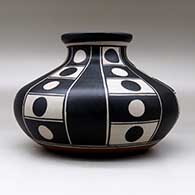 A polychrome low shouldered jar decorated with a six-panel geometric design, click or tap to see a larger version