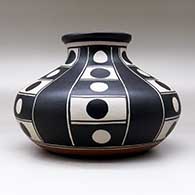 A polychrome low shouldered jar decorated with a six-panel geometric design, click or tap to see a larger version