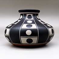 A polychrome low shouldered jar decorated with a six-panel geometric design, click or tap to see a larger version