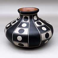 A polychrome low shouldered jar decorated with a six-panel geometric design
 by Thomas Tenorio of Santo Domingo