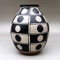 A polychrome jar decorated with a black and white geometric design, click or tap to see a larger version
