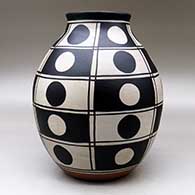 A polychrome jar decorated with a black and white geometric design, click or tap to see a larger version