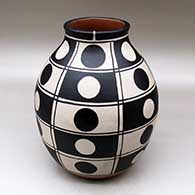 A polychrome jar decorated with a black and white geometric design
 by Thomas Tenorio of Santo Domingo