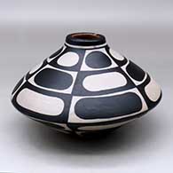 A polychrome low shouldered jar decorated with a six-panel geometric design
 by Thomas Tenorio of Santo Domingo