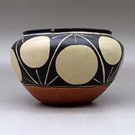 A polychrome bowl with a raised rim and decorated around the shoulder with a geometric design, click or tap to see a larger version