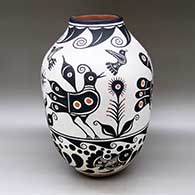 A large polychrome jar decorated with a bird, flower, fish and geometric design
 by Thomas Tenorio of Santo Domingo