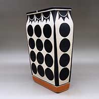 A polychrome rectangular jar decorated with a geometric design, click or tap to see a larger version