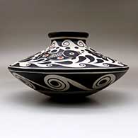 A low shouldered polychrome jar decorated with a fish, water symbol and geometric design, click or tap to see a larger version