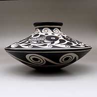 A low shouldered polychrome jar decorated with a fish, water symbol and geometric design, click or tap to see a larger version