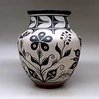 A large polychrome jar with a recurved neck and decorated with a bird, plant, flower and geometric design, click or tap to see a larger version