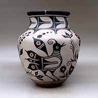 A large polychrome jar with a recurved neck and decorated with a bird, plant, flower and geometric design, click or tap to see a larger version
