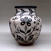 A large polychrome jar with a recurved neck and decorated with a bird, plant, flower and geometric design, click or tap to see a larger version