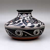 A low shouldered polychrome jar with a flared rim and decorated with a four panel fish, spiral and geometric design, click or tap to see a larger version