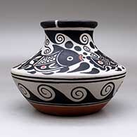 A low shouldered polychrome jar with a flared rim and decorated with a four panel fish, spiral and geometric design, click or tap to see a larger version