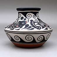 A low shouldered polychrome jar with a flared rim and decorated with a four panel fish, spiral and geometric design, click or tap to see a larger version