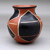 A polychrome jar with a recurved neck and decorated with a four panel geometric design
 by Robert Tenorio of Santo Domingo