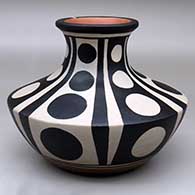 Click for a larger view A low, wide-shouldered polychrome jar with a recurved neck and decorated with a six panel geometric design
by Thomas Tenorio of Santo Domingo