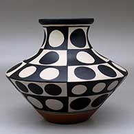 A low, wide-shouldered polychrome jar with a recurved neck and decorated with a six panel geometric design, click or tap to see a larger version