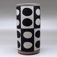 A polychrome cylinder decorated with a six-panel geometric design, click or tap to see a larger version