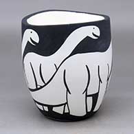 Click for a larger view A black on white jar with an organic rim and decorated with an allosaur design
by William Pacheco of Santo Domingo