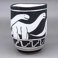 A black on white jar with an organic rim and decorated with an allosaur and geometric design
 by William Pacheco of Santo Domingo