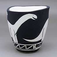 A black on white jar with an organic rim and decorated with an allosaur and geometric design
 by William Pacheco of Santo Domingo