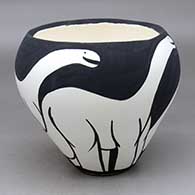 A black on white jar with an organic rim and decorated with an allosaur design
 by William Pacheco of Santo Domingo