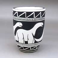 A black on white jar with an organic rim and decorated with an allosaur and geometric design
 by William Pacheco of Santo Domingo