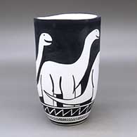 A black on white jar with an organic rim and decorated with an allosaur and geometric design
 by William Pacheco of Santo Domingo
