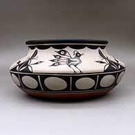 A large, wide polychrome bowl with a recurved neck and decorated inside and out with a bird and geometric design, click or tap to see a larger version