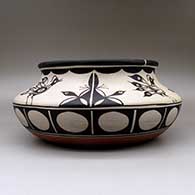 A large, wide polychrome bowl with a recurved neck and decorated inside and out with a bird and geometric design, click or tap to see a larger version