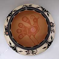 A large, wide polychrome bowl with a recurved neck and decorated inside and out with a bird and geometric design, click or tap to see a larger version