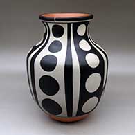 A polychrome jar with a flared neck and decorated with a six panel dot and geometric design
 by Thomas Tenorio of Santo Domingo