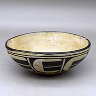 A small polychrome dough bowl polished on the inside and decorated on the outside with an eight panel geometric design
 by Unknown of Santo Domingo