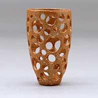 A small golden micaceous holey cylinder, click or tap to see a larger version